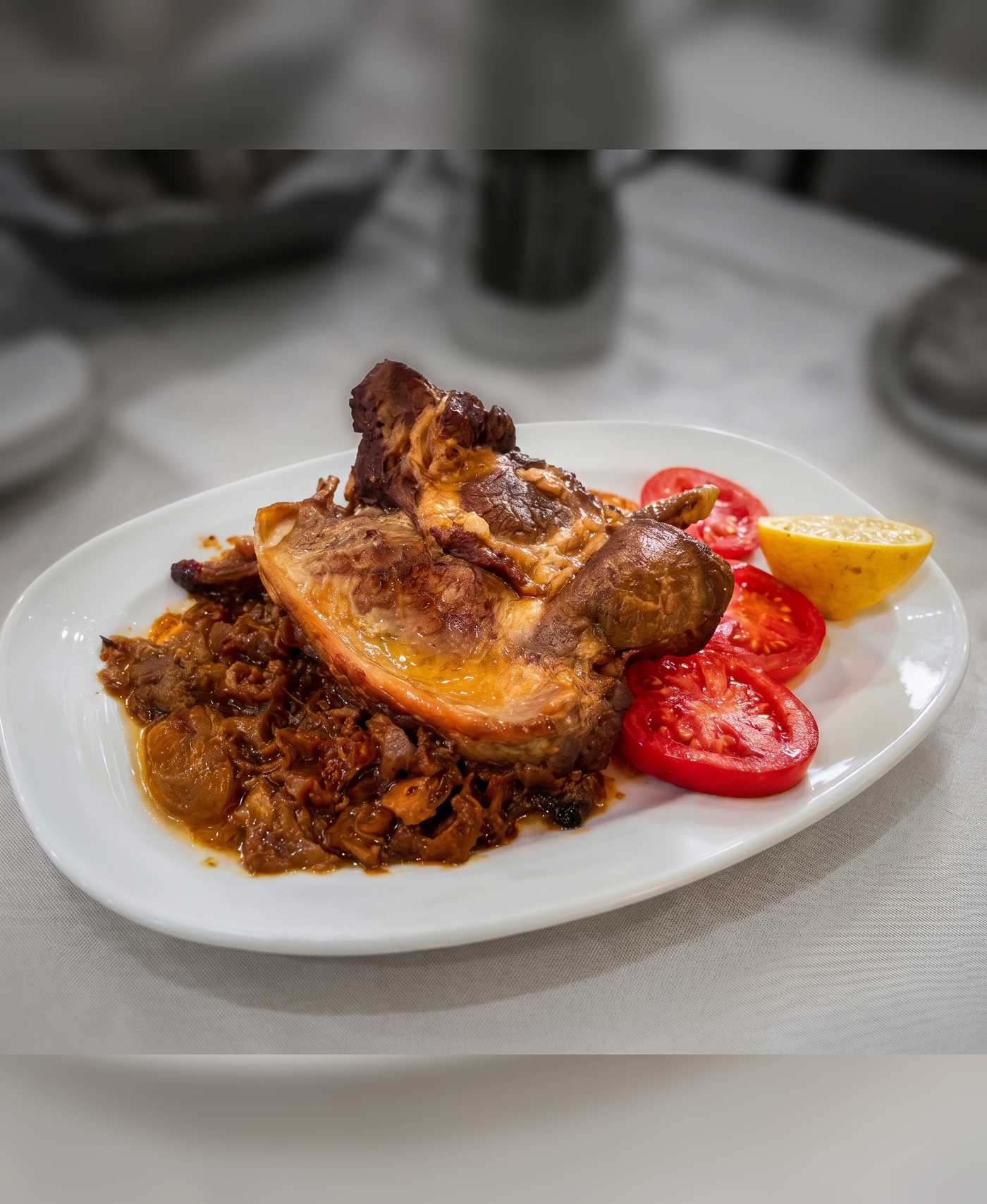 A polished meat dish with richer lighting and sharper menu texture